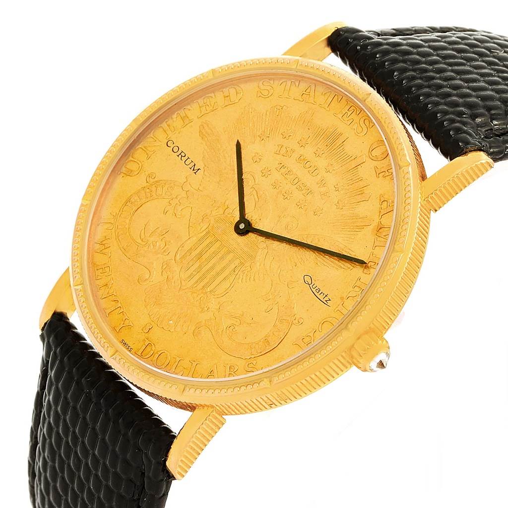 The image shows a close-up of the Corum Coin Watch Men's Yellow Gold Black Dial Men's Yellow Gold Black Dial, highlighting its engraved gold coin face and black leather strap.