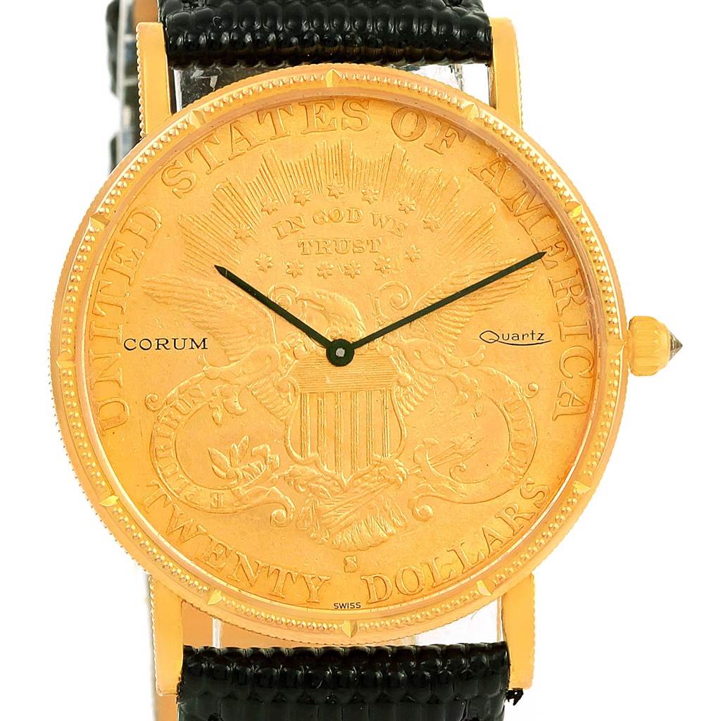 This image shows a frontal view of the Corum Coin Watch Men's Yellow Gold Black Dial Men's Yellow Gold Black Dial model, displaying its coin-like dial, black strap, and gold casing.