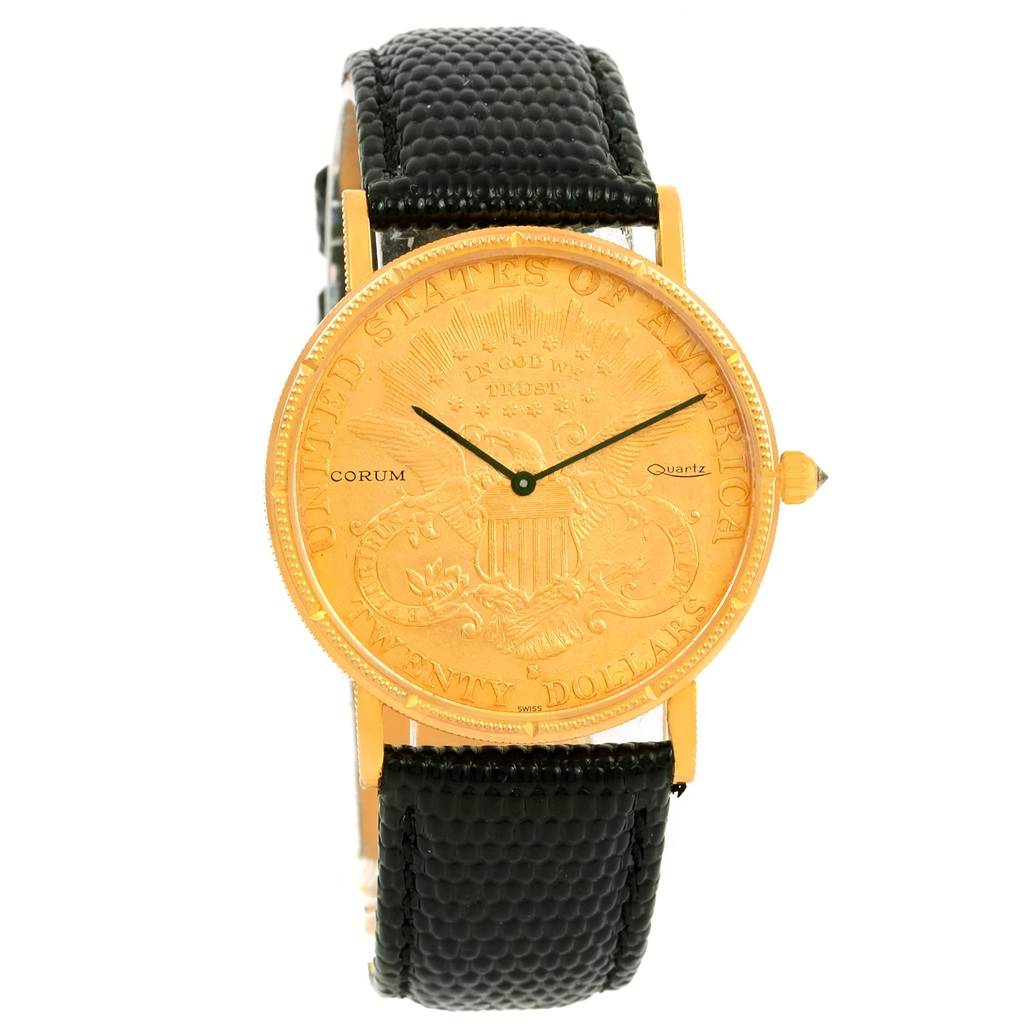 The image shows a front view of the Corum Coin Watch Men's Yellow Gold Black Dial Men's Yellow Gold Black Dial model, highlighting its gold coin dial and black leather strap.