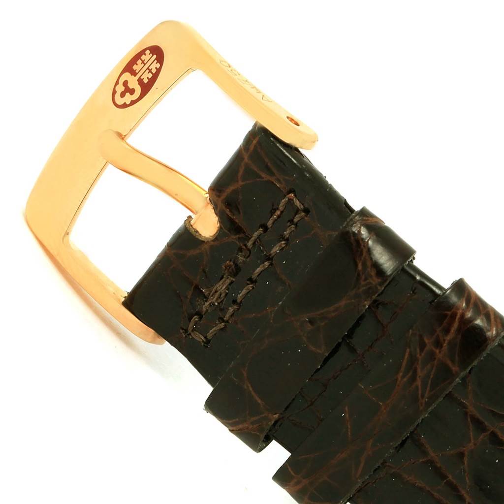 The image shows the buckle and part of the leather strap of a Corum Coin Watch Men's Yellow Gold Black Dial Men's Yellow Gold Black Dial.