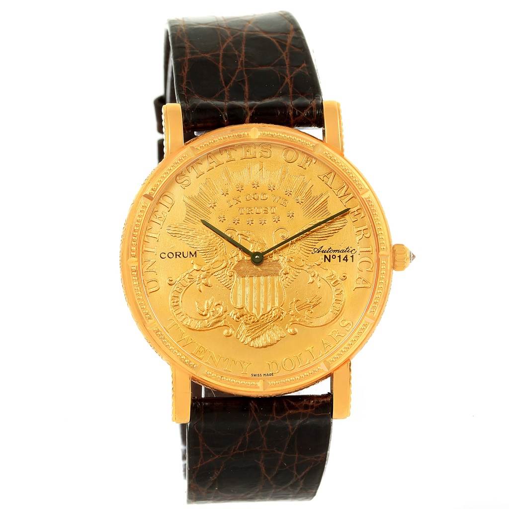 The image shows a frontal view of the Corum Coin Watch Men's Yellow Gold Black Dial Men's Yellow Gold Black Dial model, highlighting its gold coin dial and black leather strap.