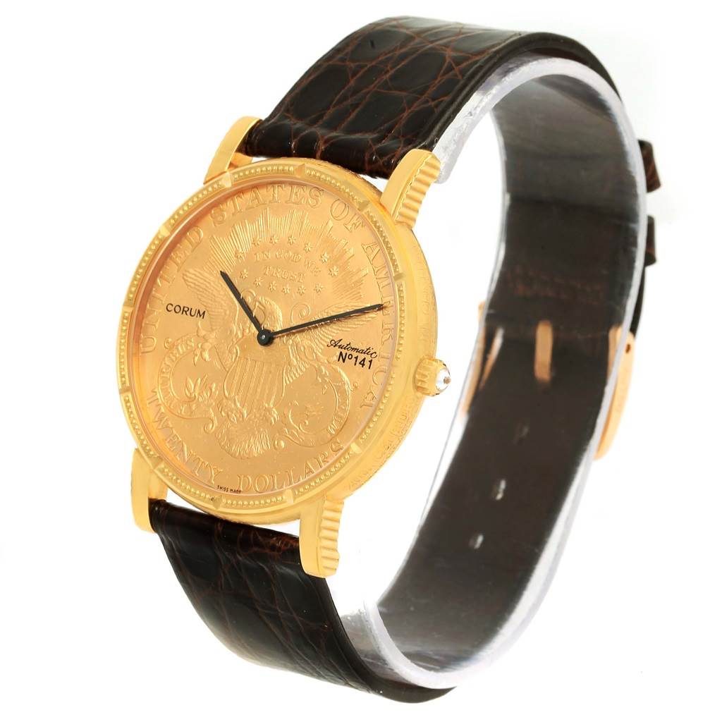 The image shows a Corum Coin Watch Men's Yellow Gold Black Dial Men's Yellow Gold Black Dial model at a three-quarter angle, highlighting its gold coin dial and black leather strap.