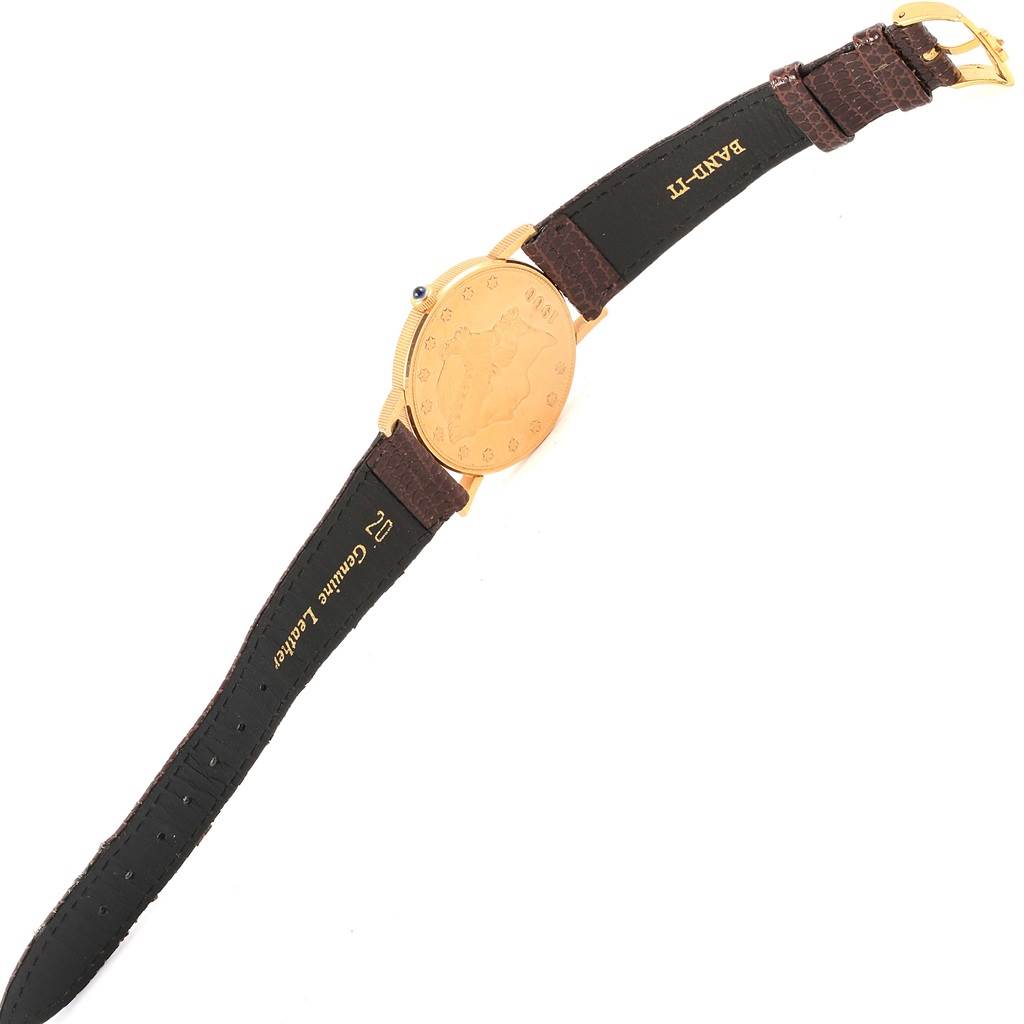 The image shows the back view of a Corum Coin Watch Men's Yellow Gold Black Dial Men's Yellow Gold Black Dial model with a gold case and a brown leather strap.