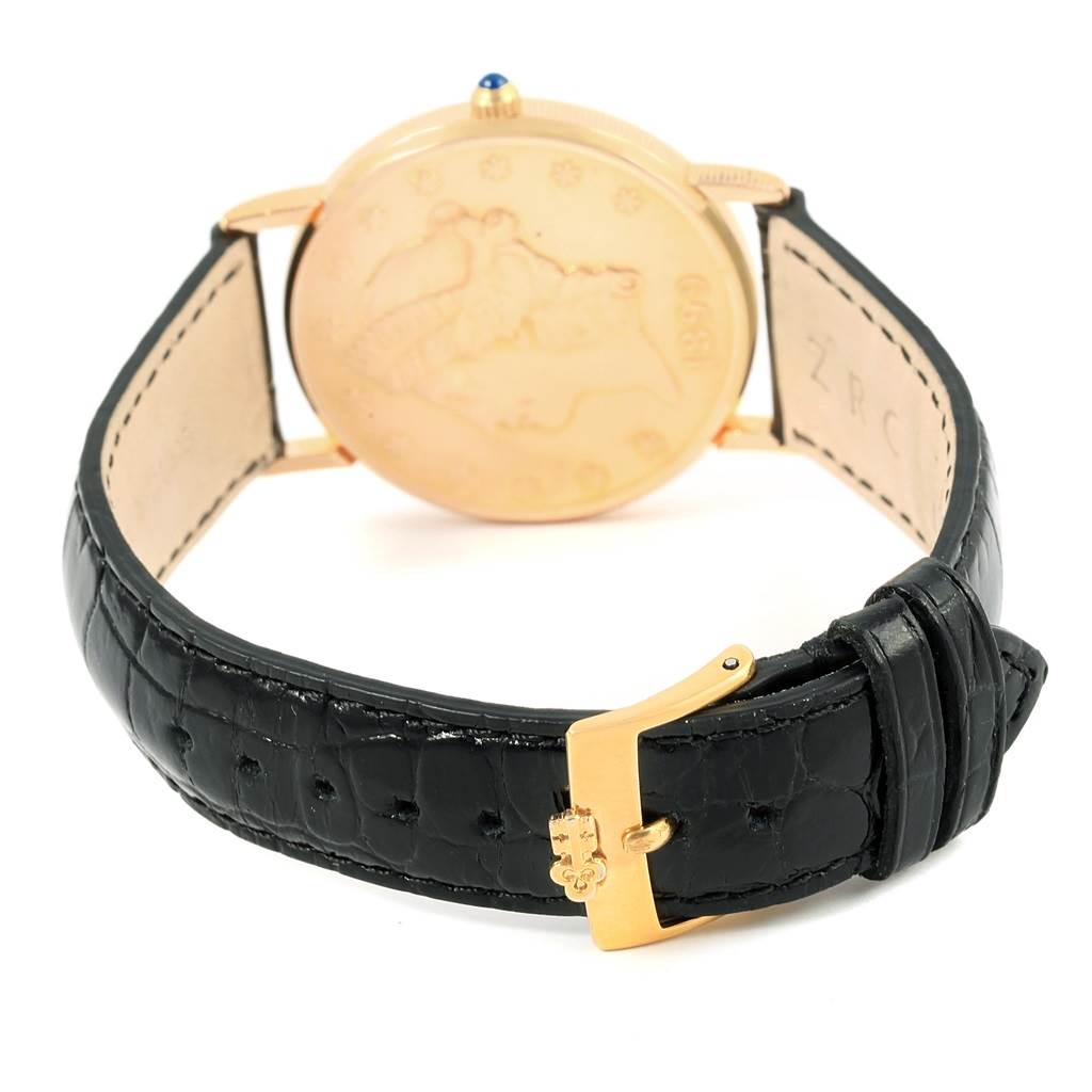 The image shows the back view of a Corum Coin Watch  Men's Yellow Gold Black Dial  Men's Yellow Gold Black Dial, highlighting its black leather strap and gold buckle.