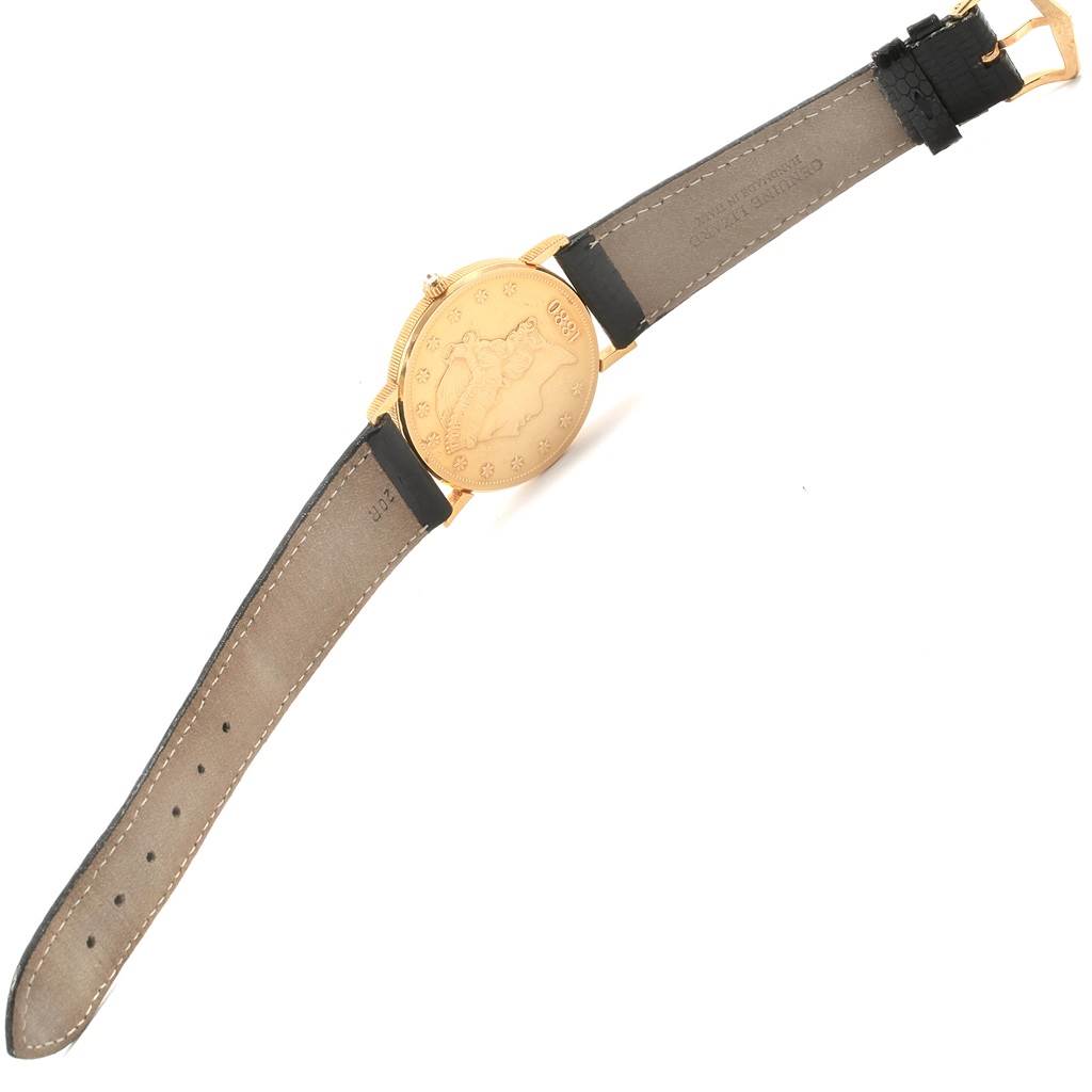 The image shows the back of the Corum Yellow Gold Black Dial Yellow Gold Black Dial 20 Dollars Double Eagle Yellow Gold Coin Year 1880 Watch laid flat, displaying the gold coin case and leather strap.