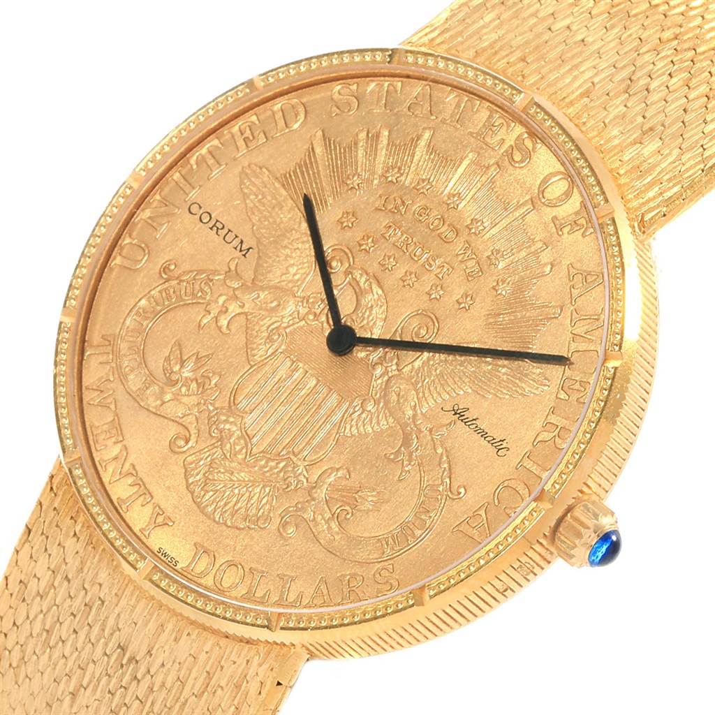 This image shows the face and strap of the Corum Coin Watch Men's Yellow Gold Black Dial Men's Yellow Gold Black Dial model, highlighting its gold design and intricate detailing.