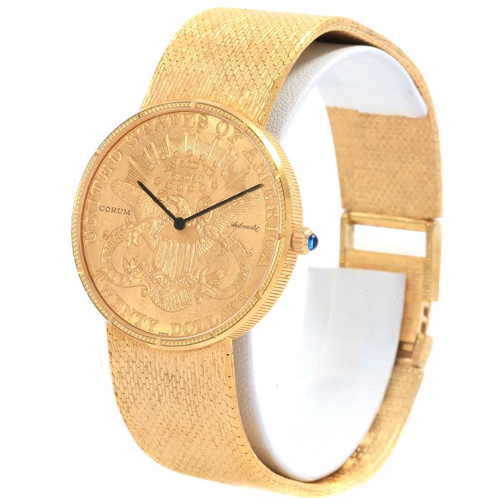 The image shows a Corum Coin Watch Men's Yellow Gold Black Dial Men's Yellow Gold Black Dial model angled to display the case, dial, crown, and part of the band.