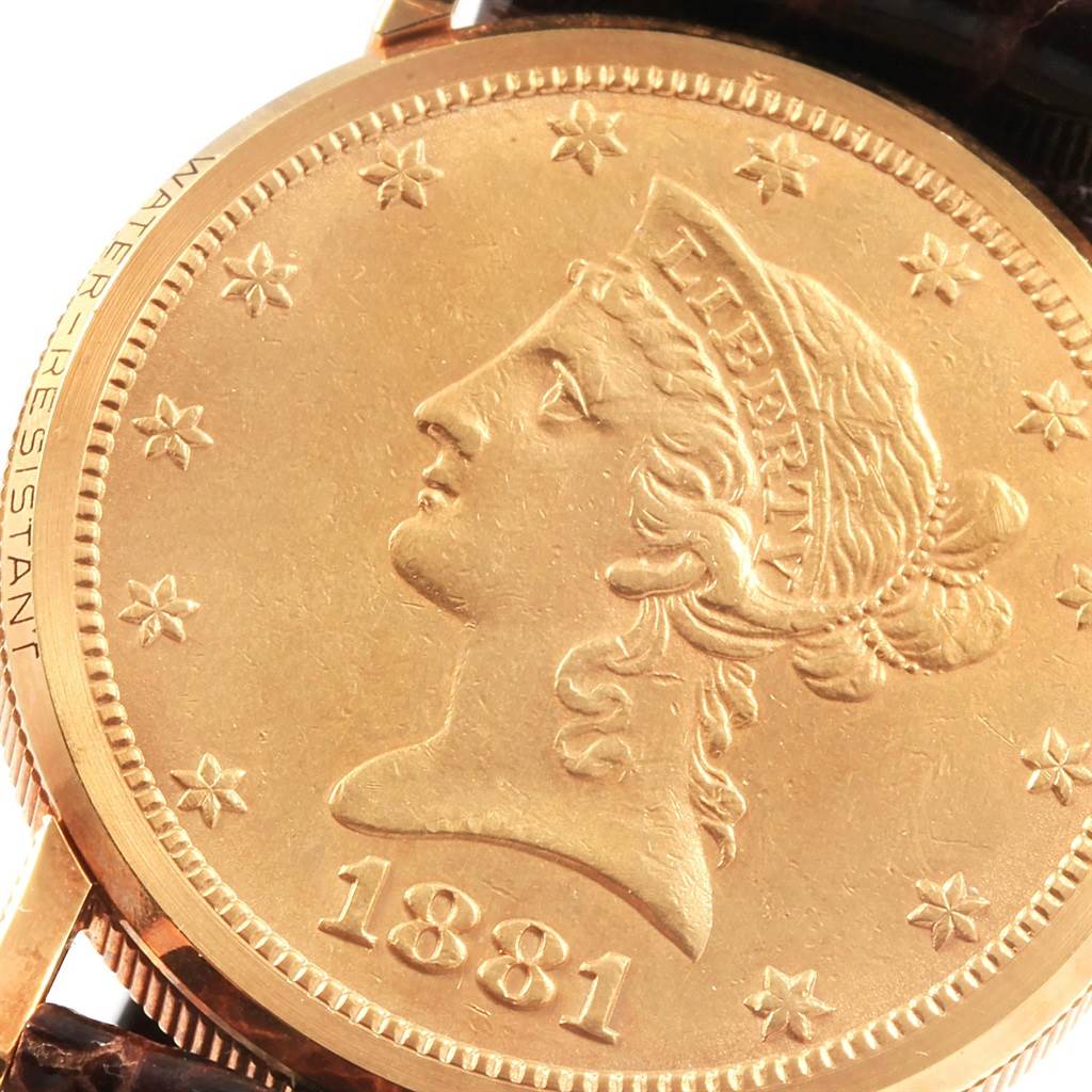 This image shows a close-up of the face of the Corum  Women's Yellow Gold Black Dial  Women's Yellow Gold Black Dial Yellow Gold 10 Dollars Coin Diamond Ladies Watch Year 1881 model.