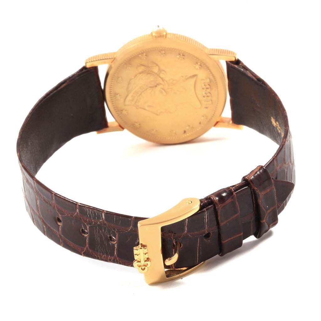 The image shows the back of the Corum  Women's Yellow Gold Black Dial  Women's Yellow Gold Black Dial Yellow Gold 10 Dollars Coin Diamond Ladies Watch Year 1881 with a leather strap and gold buckle.