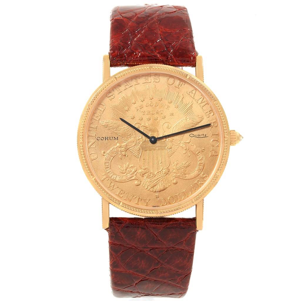 The image shows a front view of the Corum Coin Watch Men's Yellow Gold Black Dial Men's Yellow Gold Black Dial model, highlighting its coin-designed dial and leather strap.