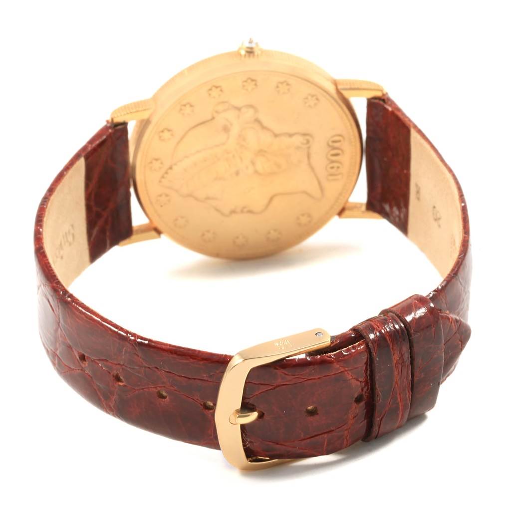 The image shows the back of a Corum Coin Watch Men's Yellow Gold Black Dial Men's Yellow Gold Black Dial model, highlighting the case back and leather strap with buckle.