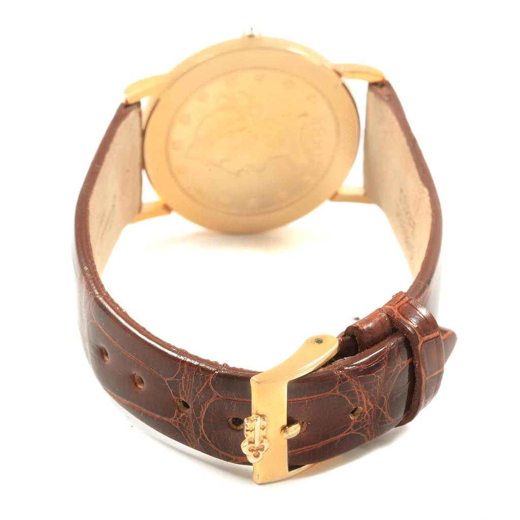 The image shows the back view of the Corum Women's Yellow Gold Black Dial Women's Yellow Gold Black Dial Yellow Gold 10 Dollars Coin Diamond Ladies Watch Year 1882 model, highlighting the buckle and strap.