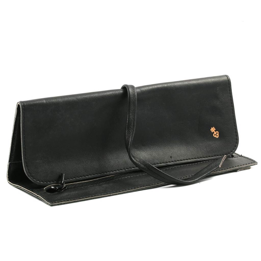 The image shows a black leather pouch for the Coin Watch model by Corum, seen from a side angle.