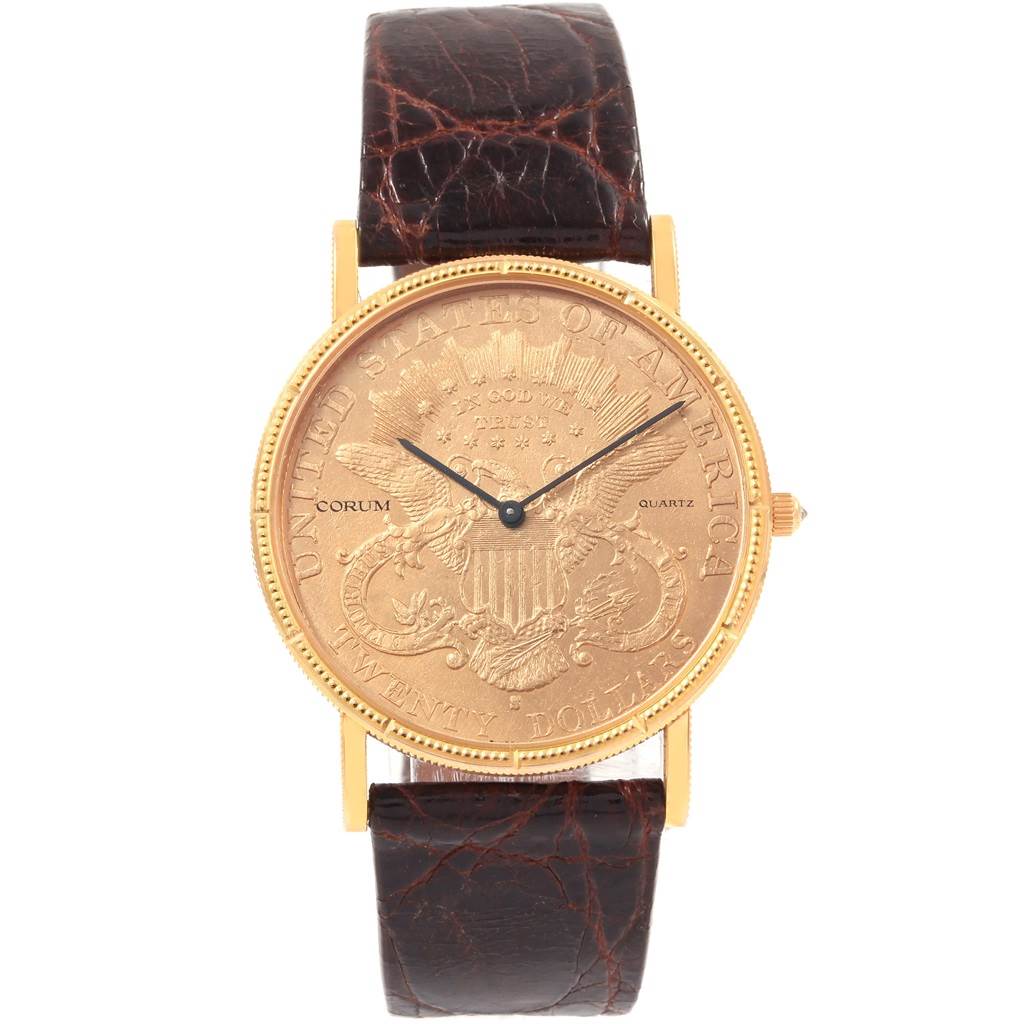 This image shows a front view of the Corum Coin Watch  Men's Yellow Gold Black Dial  Men's Yellow Gold Black Dial model, highlighting its gold dial and brown leather strap.