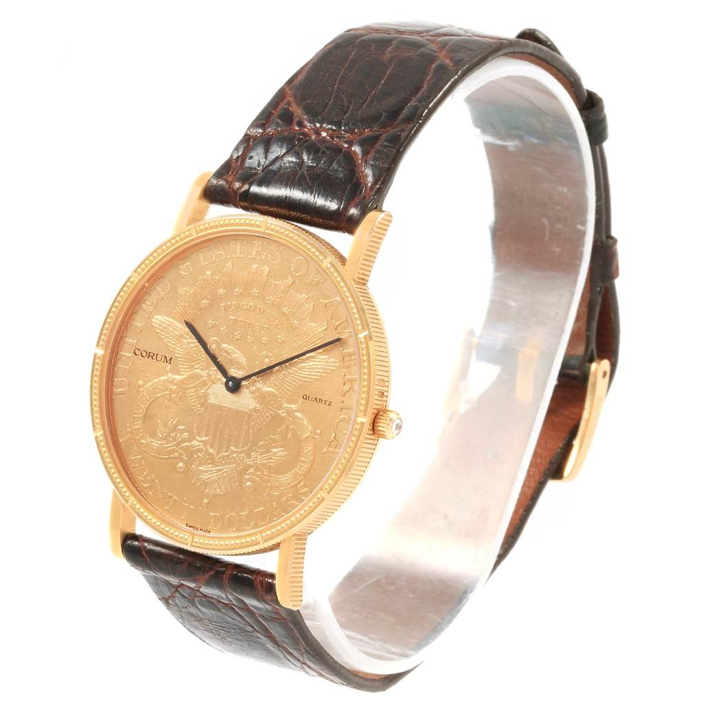 The Coin Watch model by Corum is shown from a side angle, displaying its engraved face, crown, and leather strap.