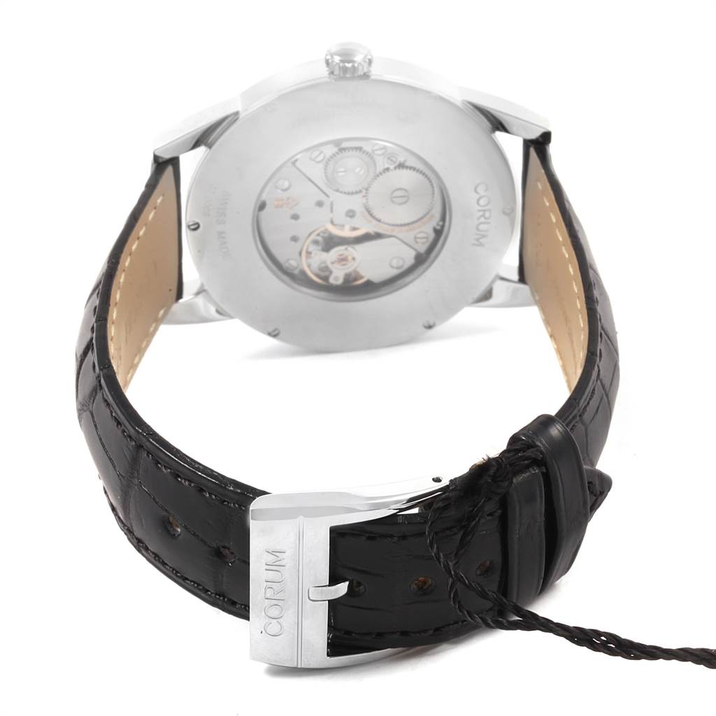 The image shows the back view of a Corum Heritage V157/02614 Men's Stainless Steel Silver Dial V157/02614 Men's Stainless Steel Silver Dial watch, highlighting its transparent case back and branded leather strap.