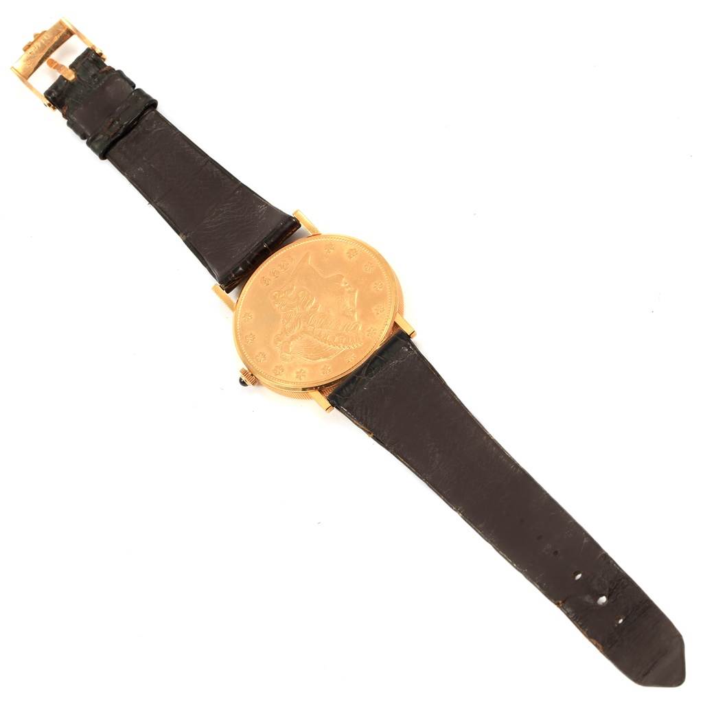 The image shows a top-down view of the Corum Coin Watch Men's Yellow Gold Black Dial Men's Yellow Gold Black Dial model, fully displaying its face and leather strap.