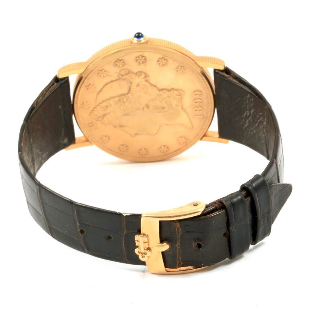 The image shows a rear view of a Corum Coin Watch Men's Yellow Gold Black Dial Men's Yellow Gold Black Dial model, featuring the back case, strap, and buckle.