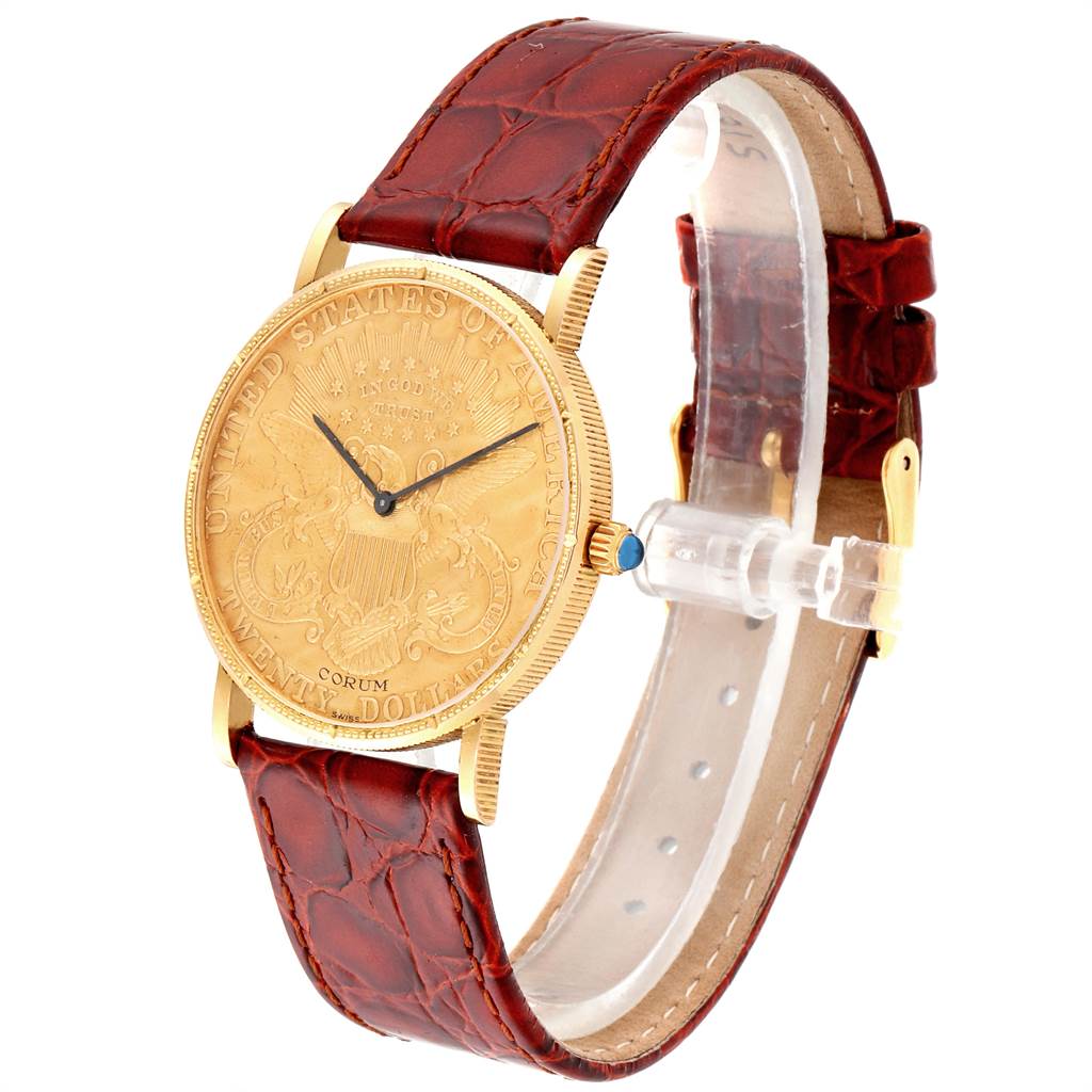 The Corum Coin Watch Men's Yellow Gold Black Dial Men's Yellow Gold Black Dial model is shown at a three-quarter angle, showcasing the watch face, bezel, and brown leather strap.