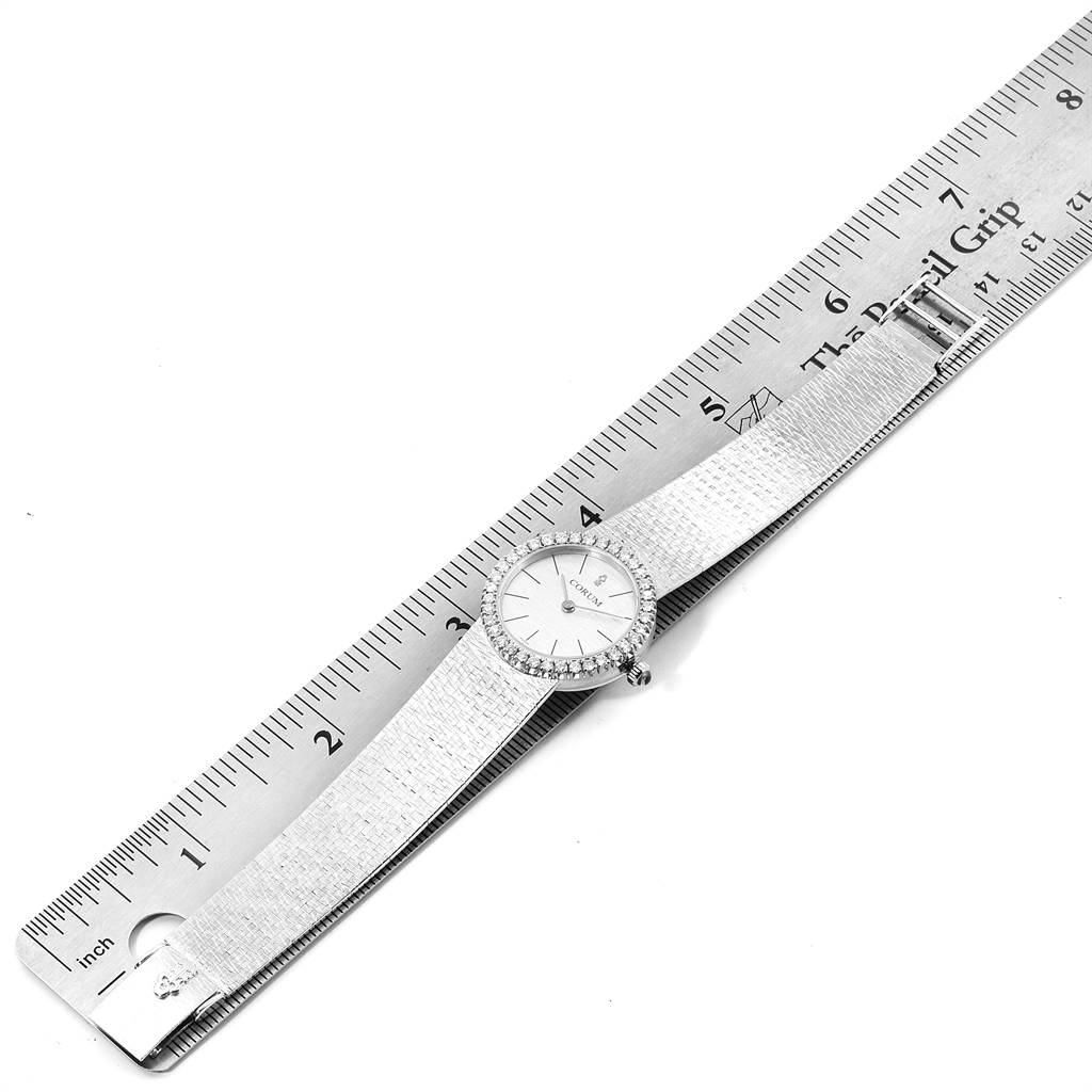 The image shows a top-down view of the Corum 80358 Women's White Gold Silver Dial 80358 Women's White Gold Silver Dial 18K White Gold Diamond Vintage Cocktail Ladies Watch, placed alongside a ruler for scale.