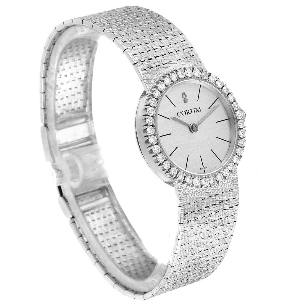 The image shows the front and side profile of the Corum 80358 Women's White Gold Silver Dial 80358 Women's White Gold Silver Dial 18K White Gold Diamond Vintage Cocktail Ladies Watch, highlighting its face and bracelet.