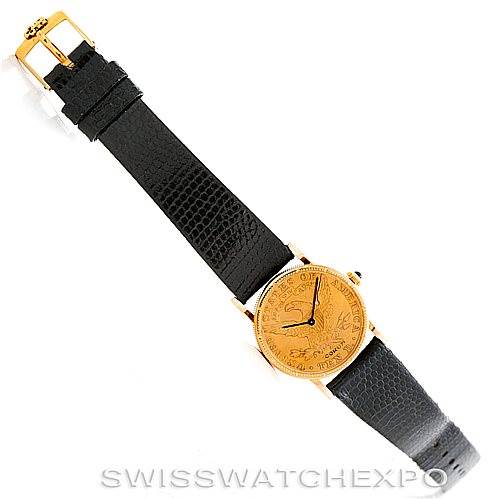The image shows a top view of the Corum Women's Yellow Gold Black Dial Women's Yellow Gold Black Dial Vintage Ladies 18K Yellow Gold 10 Dollars Coin Watch, highlighting the strap and the watch face.
