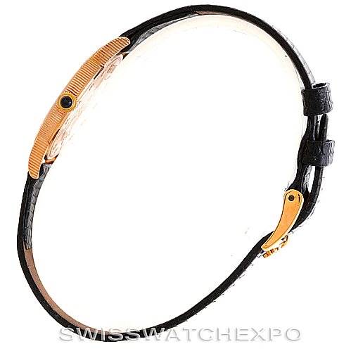 This image shows a side view of the Corum Women's Yellow Gold Black Dial Women's Yellow Gold Black Dial Vintage Ladies 18K Yellow Gold 10 Dollars Coin Watch, highlighting the case and strap.