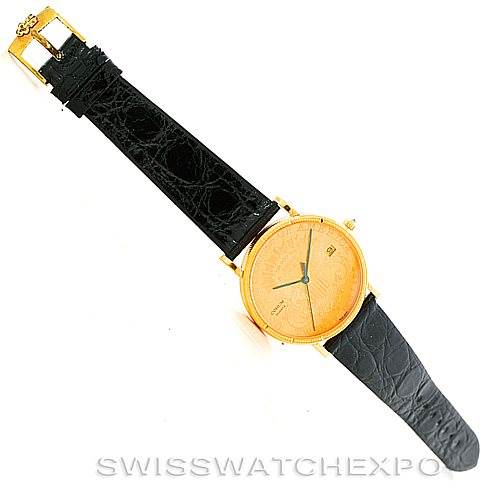 The image shows a Corum Coin Watch Men's Yellow Gold Black Dial Men's Yellow Gold Black Dial model, featuring a full view of the watch with its round dial and black leather strap.