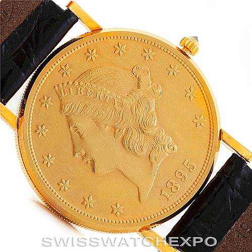 The image shows a close-up of the face and lugs of the Corum Coin Watch Men's Yellow Gold Black Dial Men's Yellow Gold Black Dial model, featuring a gold coin design with an 1895 date.