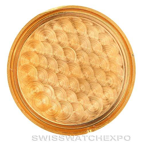 This image shows the case back of a Vintage Corum watch from an inside view with a textured, circular pattern.