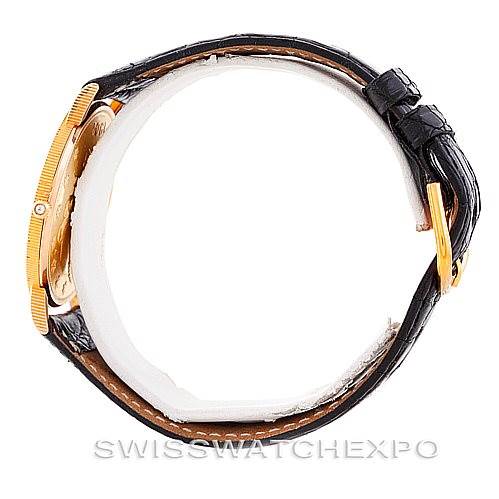 Side view of a Vintage Corum watch, showcasing the case and leather strap with a gold buckle.