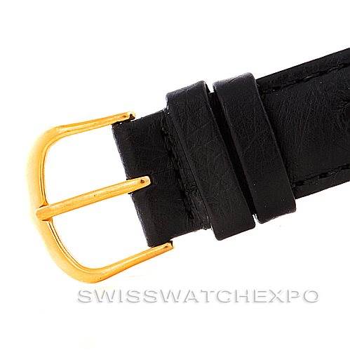 The image shows a close-up of the black leather strap and gold-toned buckle of a Vintage Corum watch.