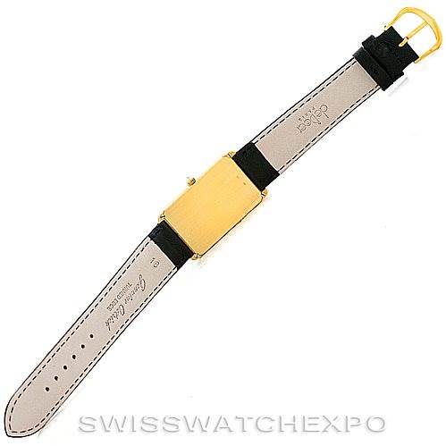 The image shows the back view of a Vintage Corum watch, focusing on the gold rectangular case and the leather straps.