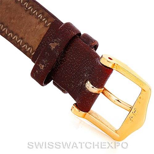 The image shows a close-up of the leather strap and gold buckle of the Corum Women's Yellow Gold Black Dial Women's Yellow Gold Black Dial Vintage Ladies 18K Yellow Gold 5 Dollars Coin Watch.