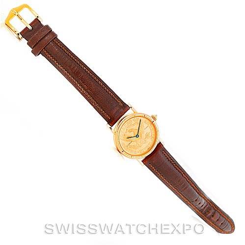 This is a top-view image of the Corum Women's Yellow Gold Black Dial Women's Yellow Gold Black Dial Vintage Ladies 18K Yellow Gold 5 Dollars Coin Watch, showing the entire watch and brown leather strap.