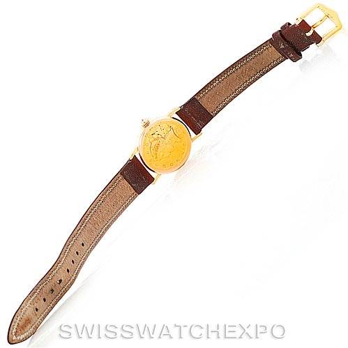 The Corum Women's Yellow Gold Black Dial Women's Yellow Gold Black Dial Vintage Ladies 18K Yellow Gold 5 Dollars Coin Watch is shown fully extended, highlighting the gold case, leather strap, and buckle.