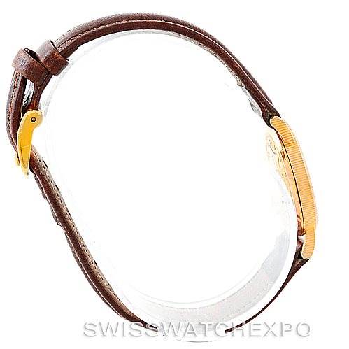 The image shows a side view of the Corum Women's Yellow Gold Black Dial Women's Yellow Gold Black Dial Vintage Ladies 18K Yellow Gold 5 Dollars Coin Watch, highlighting the case and leather strap.