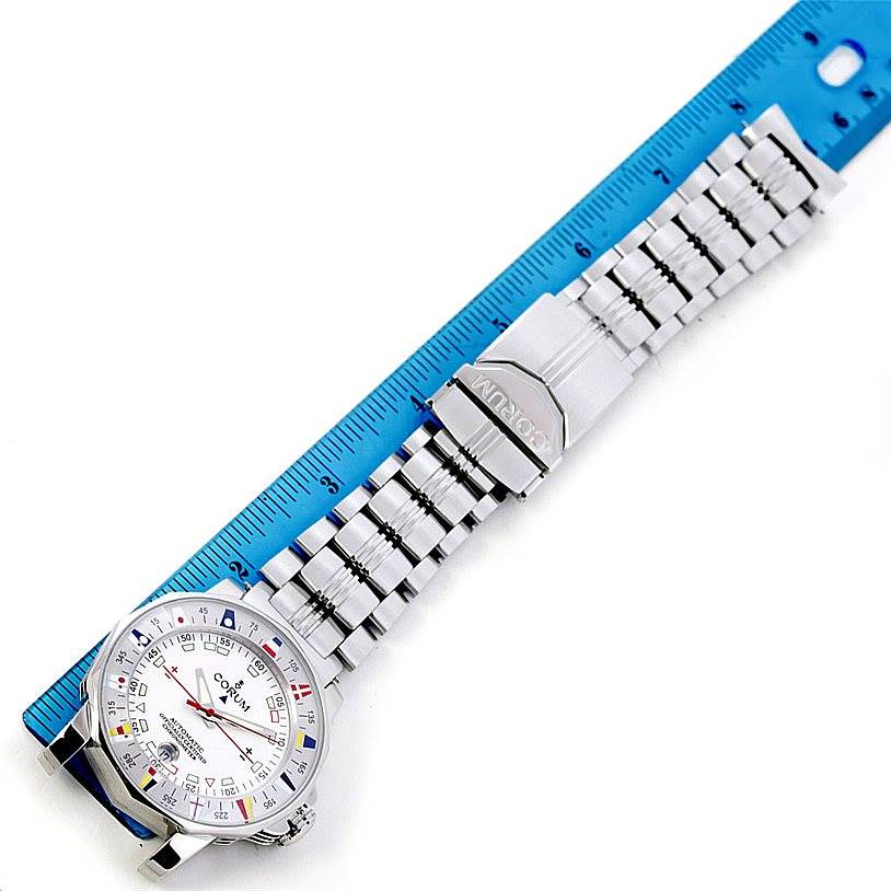 The image shows a full view of the Corum Admiral
s Cup watch with its bracelet aligned next to a blue ruler.