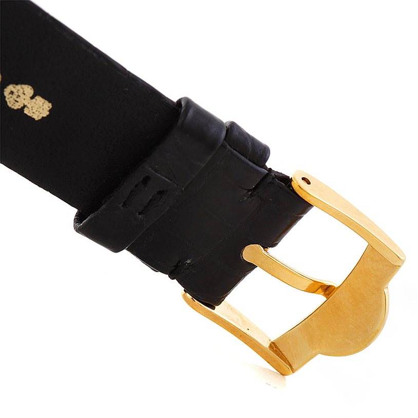 This image shows a close-up of the gold buckle and black leather strap of the Corum Coin Watch Men's Yellow Gold Black Dial Men's Yellow Gold Black Dial model.