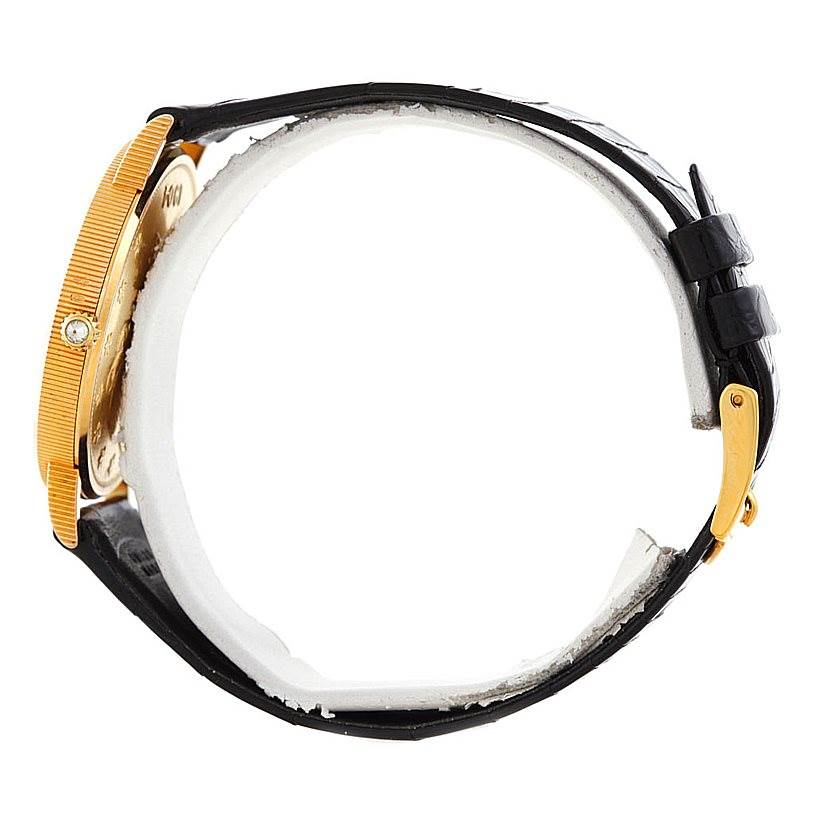 The Corum Coin Watch Men's Yellow Gold Black Dial Men's Yellow Gold Black Dial model is shown from a side angle, highlighting the case, strap, and buckle.