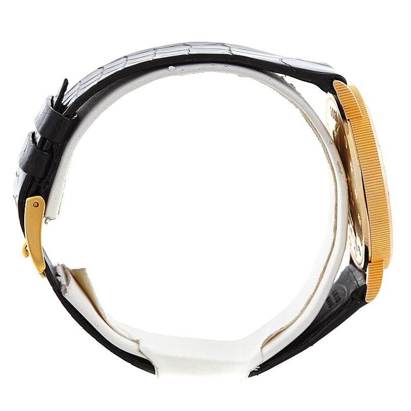 This image shows the Corum Coin Watch Men's Yellow Gold Black Dial Men's Yellow Gold Black Dial model from a side angle, highlighting the case, strap, and buckle.