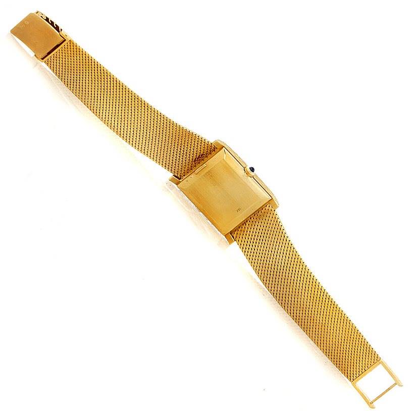 This image shows a top view of a Vintage Corum watch with a rectangular case and a gold mesh bracelet.