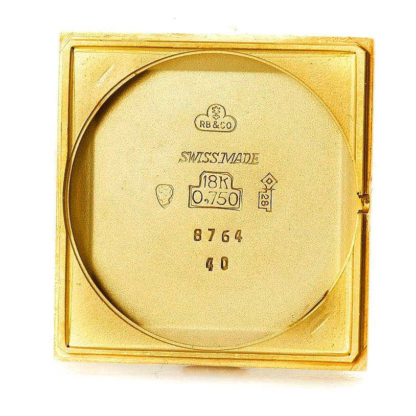 The image shows the back inner casing of a Vintage Corum watch, highlighting the 18K gold mark and other inscriptions.
