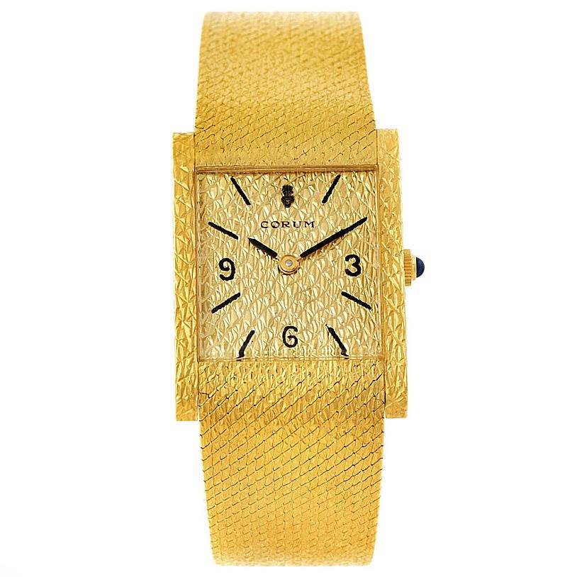 This image shows a front view of a gold Vintage model watch by Corum, highlighting its textured dial and matching band.