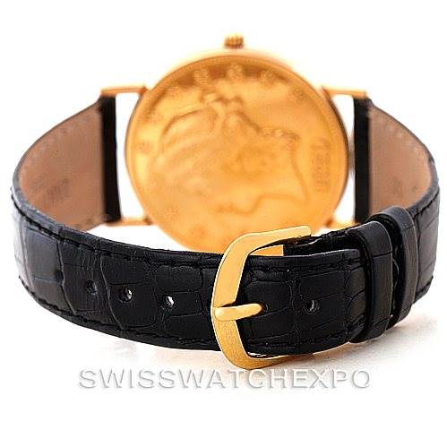 This image shows the back of a Corum Vintage watch, highlighting its gold case and black leather strap with a gold buckle.