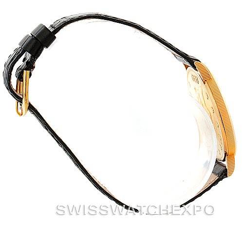 Side view of a Vintage Corum watch showing the leather strap, buckle, and part of the gold case.