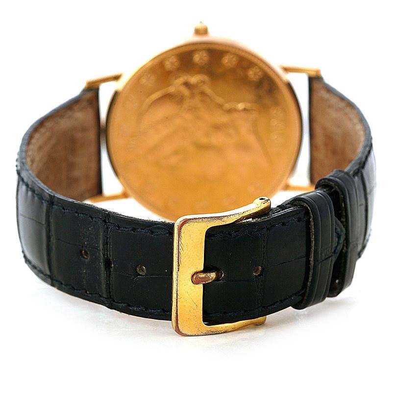 This image shows the back of the Coin Watch model by Corum, highlighting the black leather strap and gold buckle.