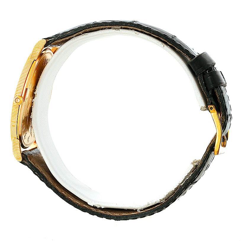 The image shows a side view of the Corum Coin Watch Men's Yellow Gold Black Dial Men's Yellow Gold Black Dial model, highlighting its case, strap, and buckle.