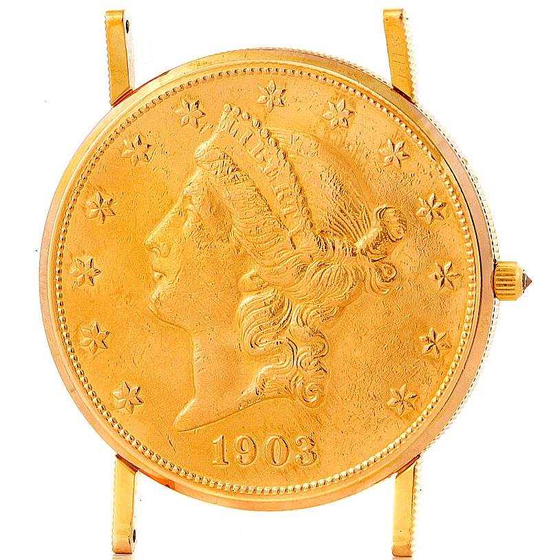 The image shows the face and crown of a Corum Coin Watch Men's Yellow Gold Black Dial Men's Yellow Gold Black Dial model, featuring a gold coin design.