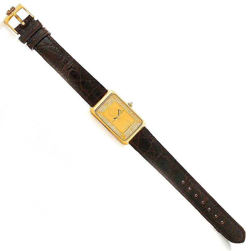 The Corum 42456 Women's Yellow Gold Champagne Dial 42456 Women's Yellow Gold Champagne Dial 18K Yellow Gold Diamond 5 Gram Ingot 999.9 Watch is shown from a top-down angle, displaying the face, bezel, and strap.